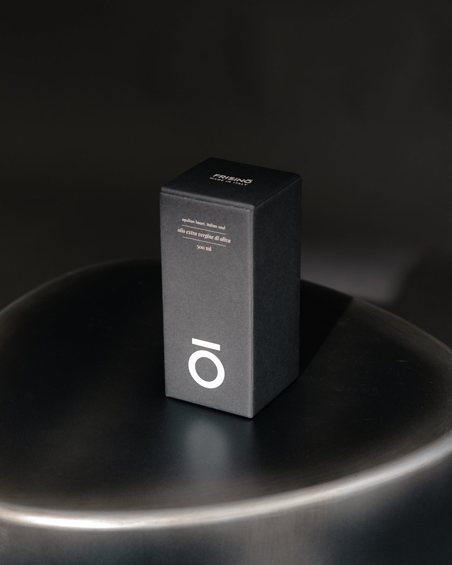 Elegant black Frisino extra virgin olive oil 500 ml giftbox, Numbers edition, on a dark surface