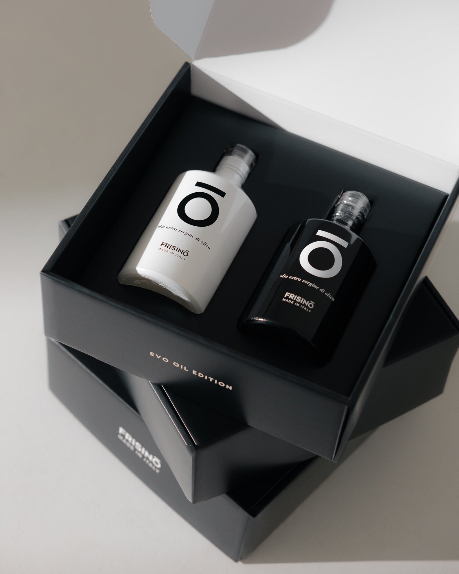 Frisino EVO Oil Edition giftbox with two extra virgin olive oil bottles, one white and one black, Made in Italy